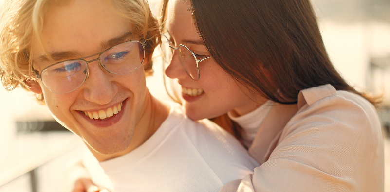 Couple hugging both wearing glasses