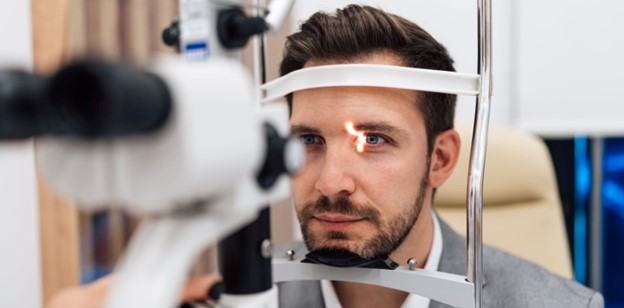 A man having an eye exam at the eye doctors office.
