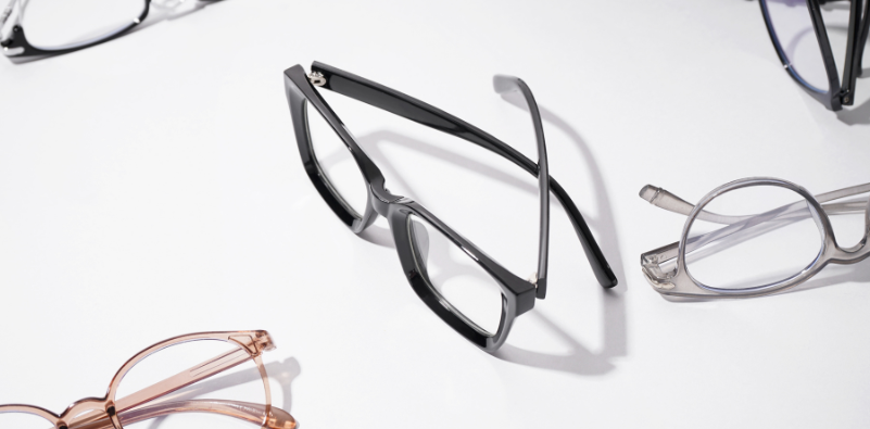 A selection of eyewear in various colors on a white surface.