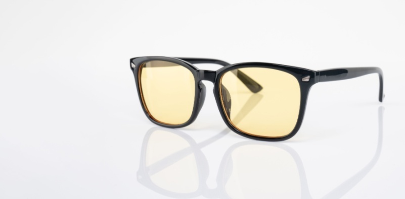 A pair of eyeglasses with yellow tinted lenses.