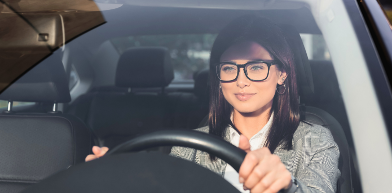 Woman driving a car, wearing glasses